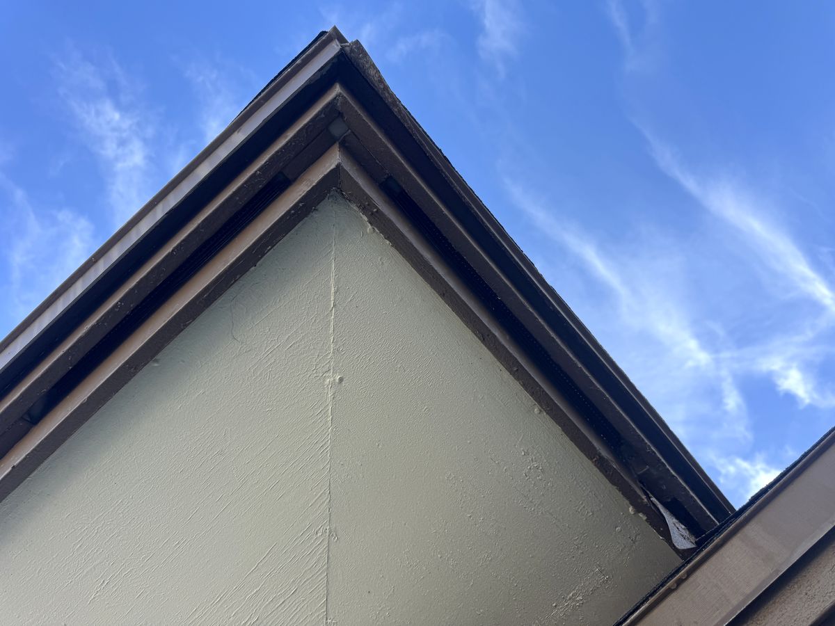 The same eave corner after sealing, seen from a different angle: the fascia and soffit meet with no opening.